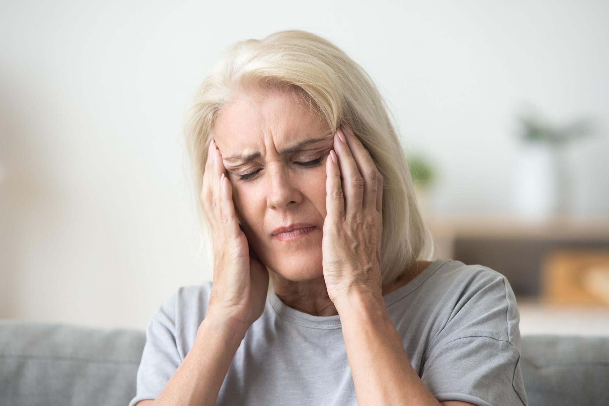 Older woman suffering from dizziness and vertigo