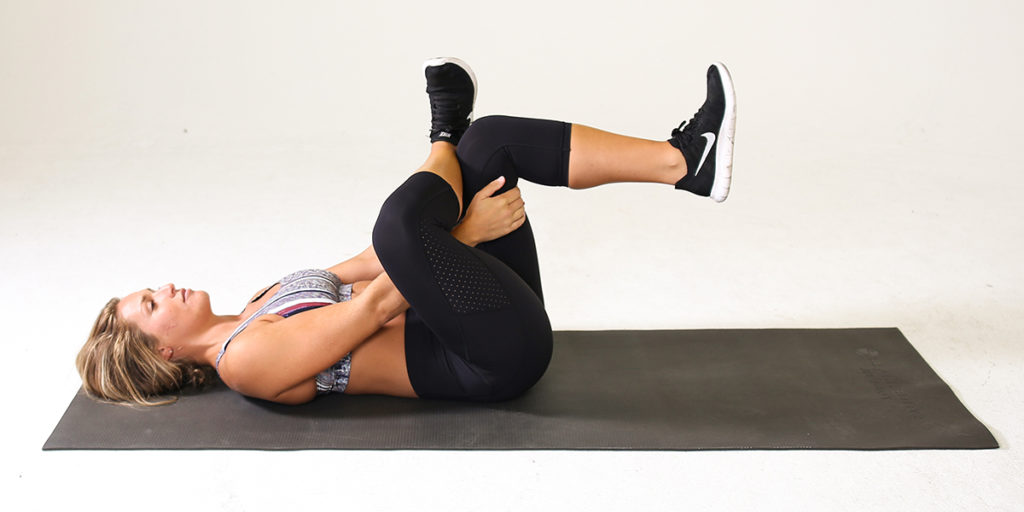 Woman performing Supine Figure 4 Stretch for Lower Back Pain