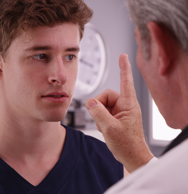 Doctor performing and eye test to detect concussion