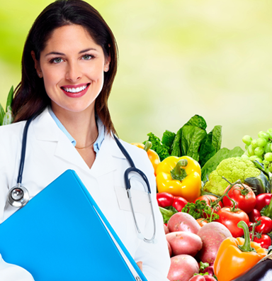Nutritionist standing next to a bowl of vegetables